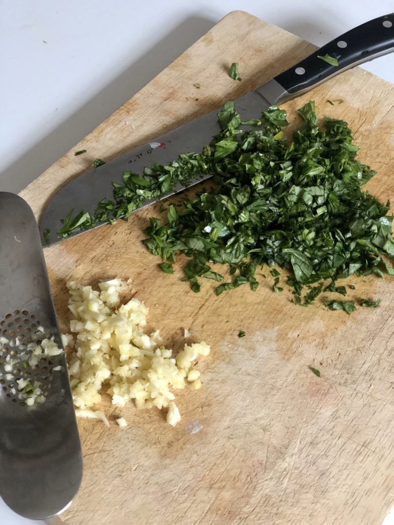 Chopped basil and garlic for homemade pasta sauce.