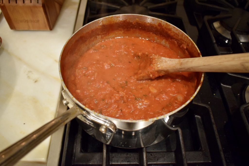 Simmering easy homemade pasta sauce in saucepan on stove.
