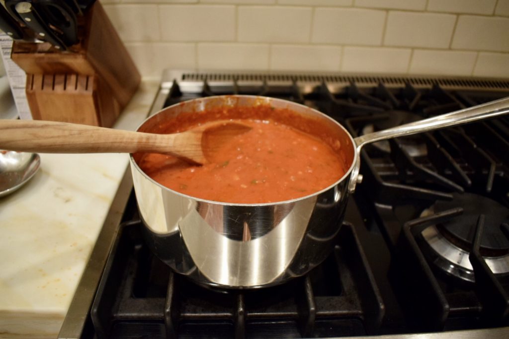Simmering easy homemade pasta sauce in saucepan on stove.